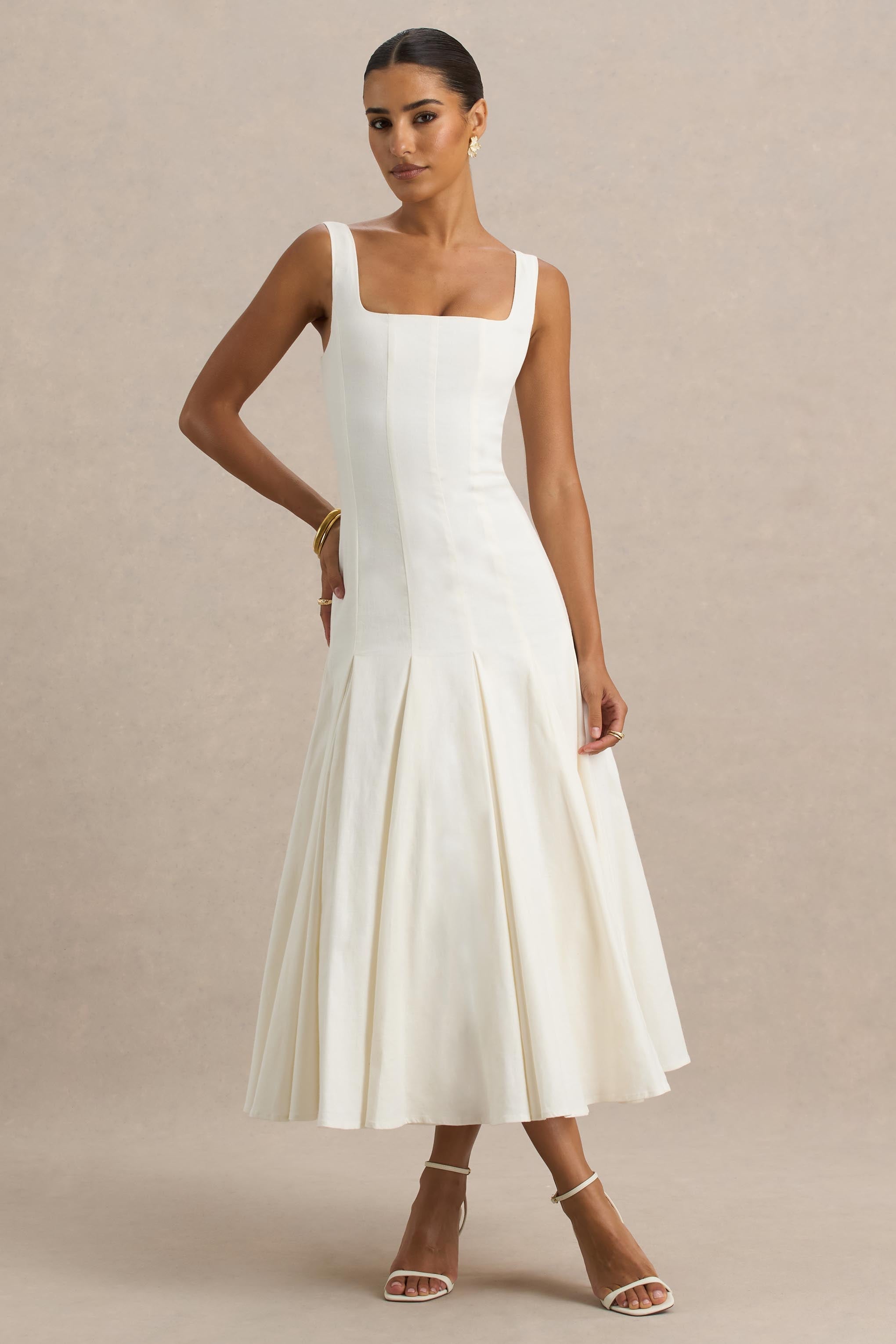 Magnolia | Weißes Midikleid mit Rundhalsausschnitt, tief sitzender Taille und Rüschendetails.